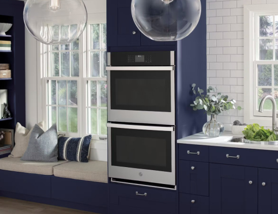 built-in ovens in a navy blue themed kitchen